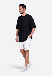 Man wearing white cotton shorts with side pockets and elastic waistband by East Vibe